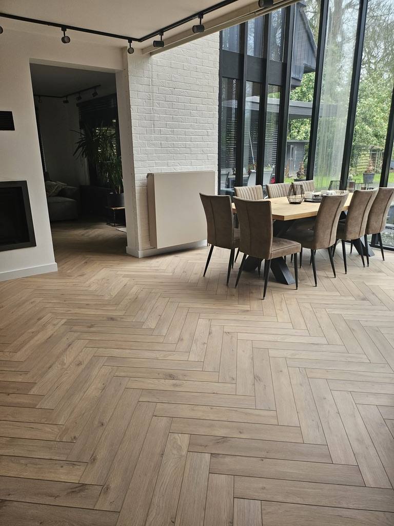 Herringbone parquet floor in an open living space with dining table
