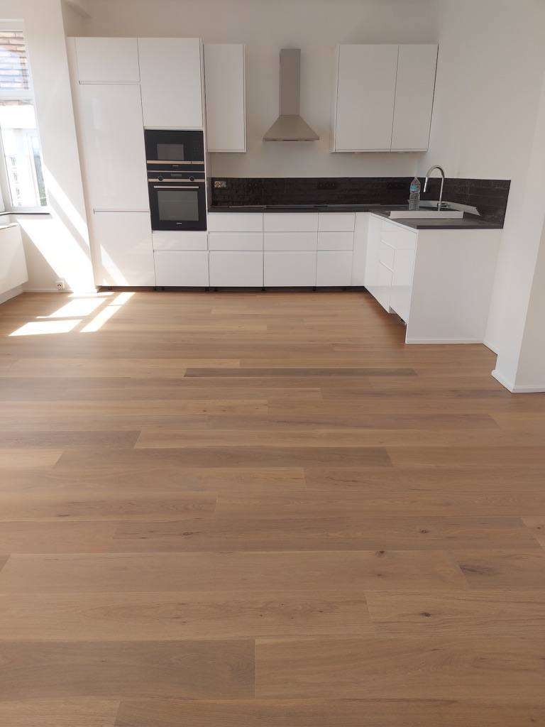Wide oak plank flooring in a bright kitchen